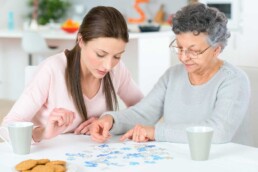 two women doing a puzzle