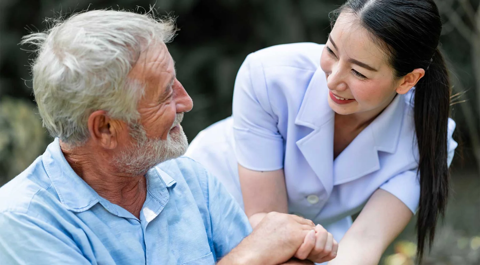 caregiver smiling at senior man